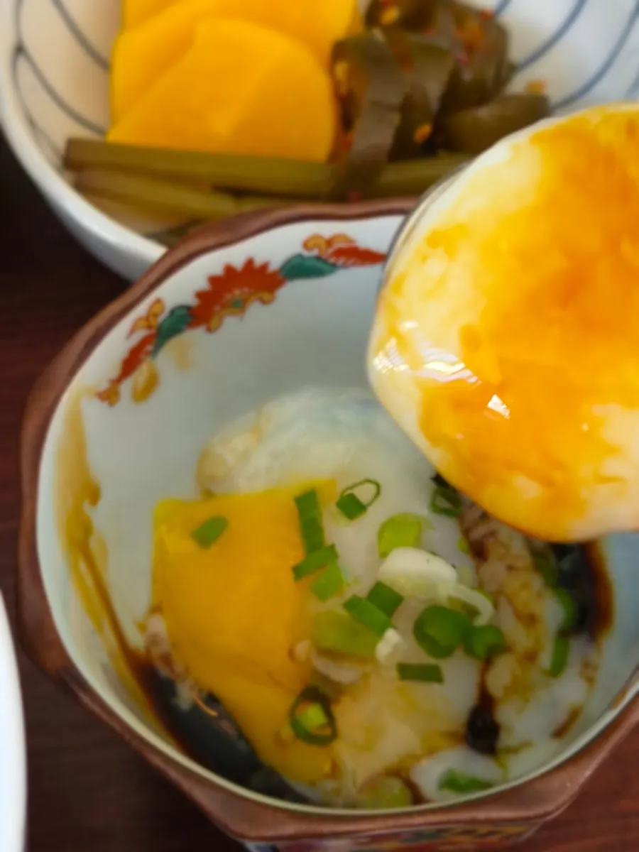Onsen tamago yolk placed on top of the rice bowl