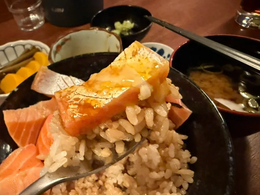 A spoonful of salmon and egg scooped up together with rice