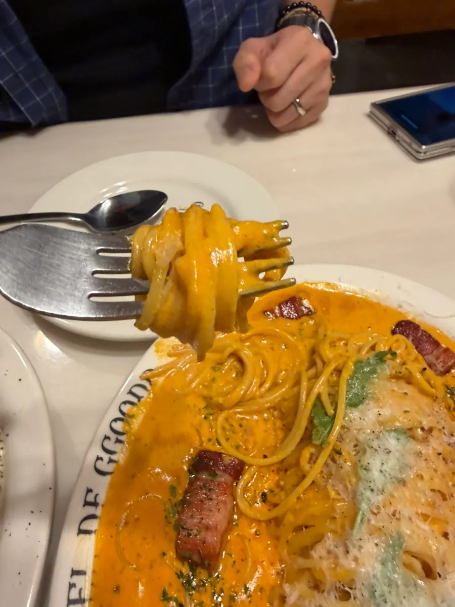 Close-up of cheese-topped rosé pasta