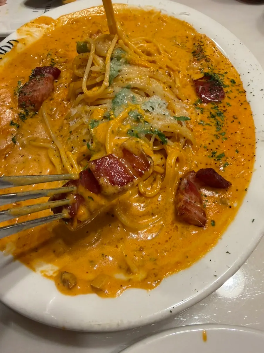 Rosé pasta twirled around a fork