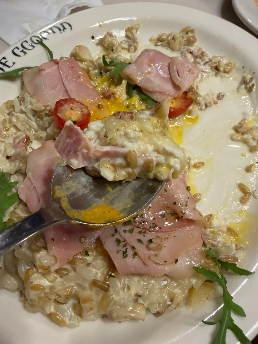 Spoonful of cream risotto with the yolk broken