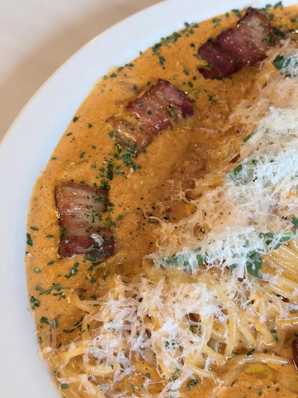 Thick rosé sauce coating the pasta noodles