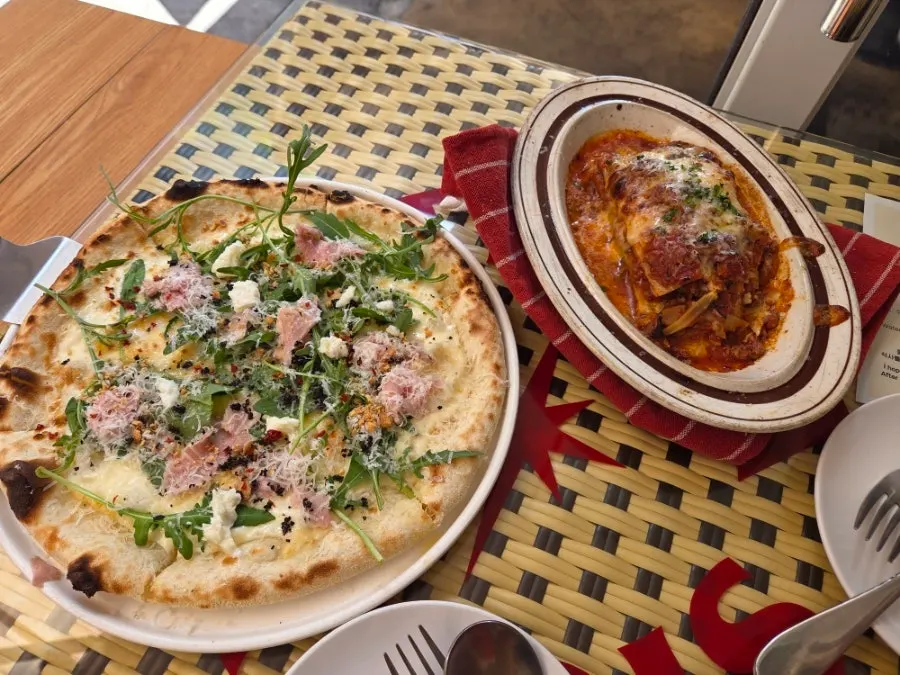 Table set with lasagna and pizza together