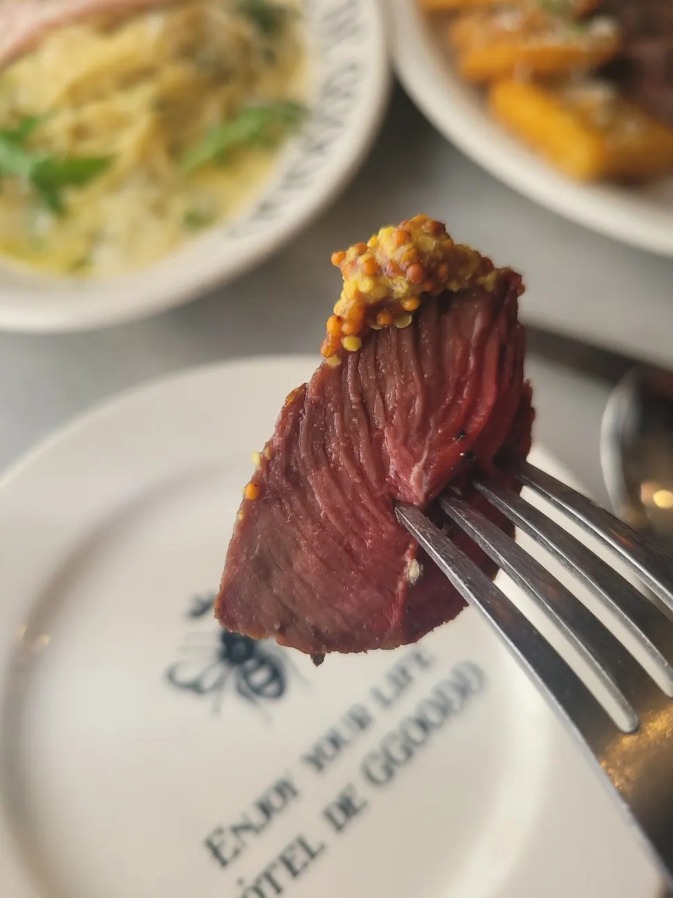 Piece of steak topped with whole-grain mustard