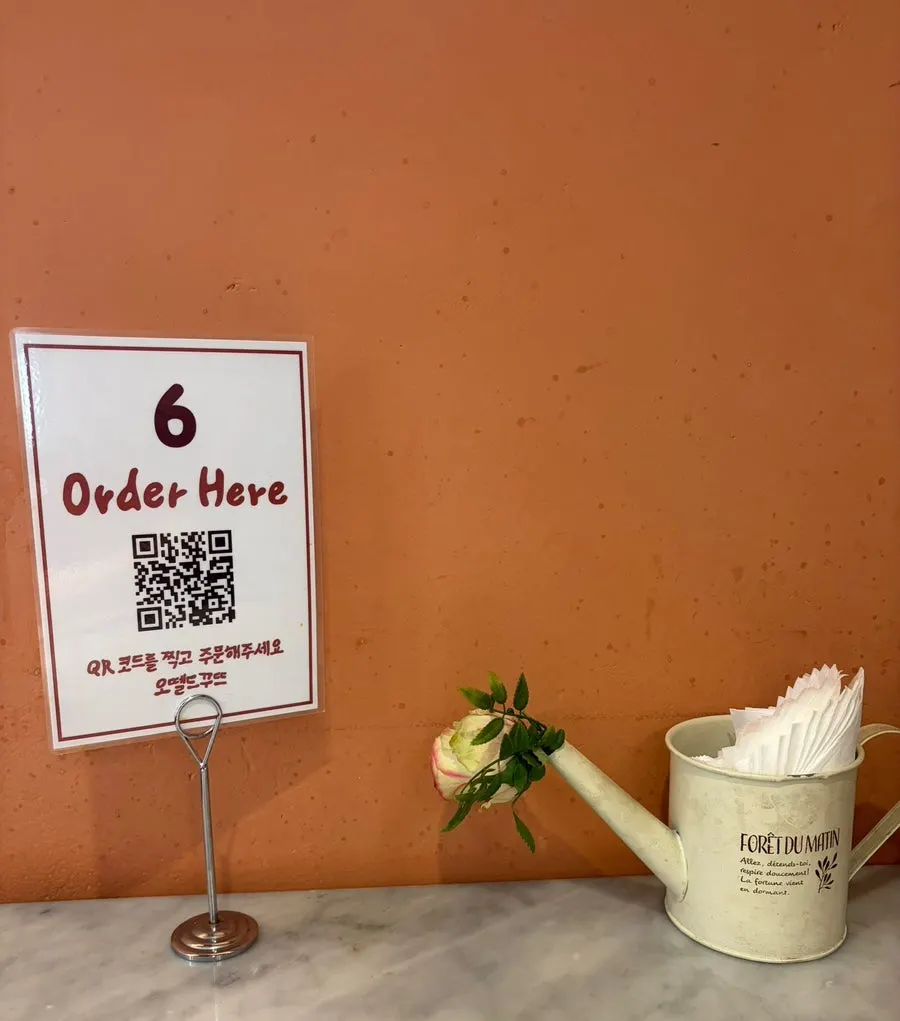 Restaurant space decorated with small objects and postcards