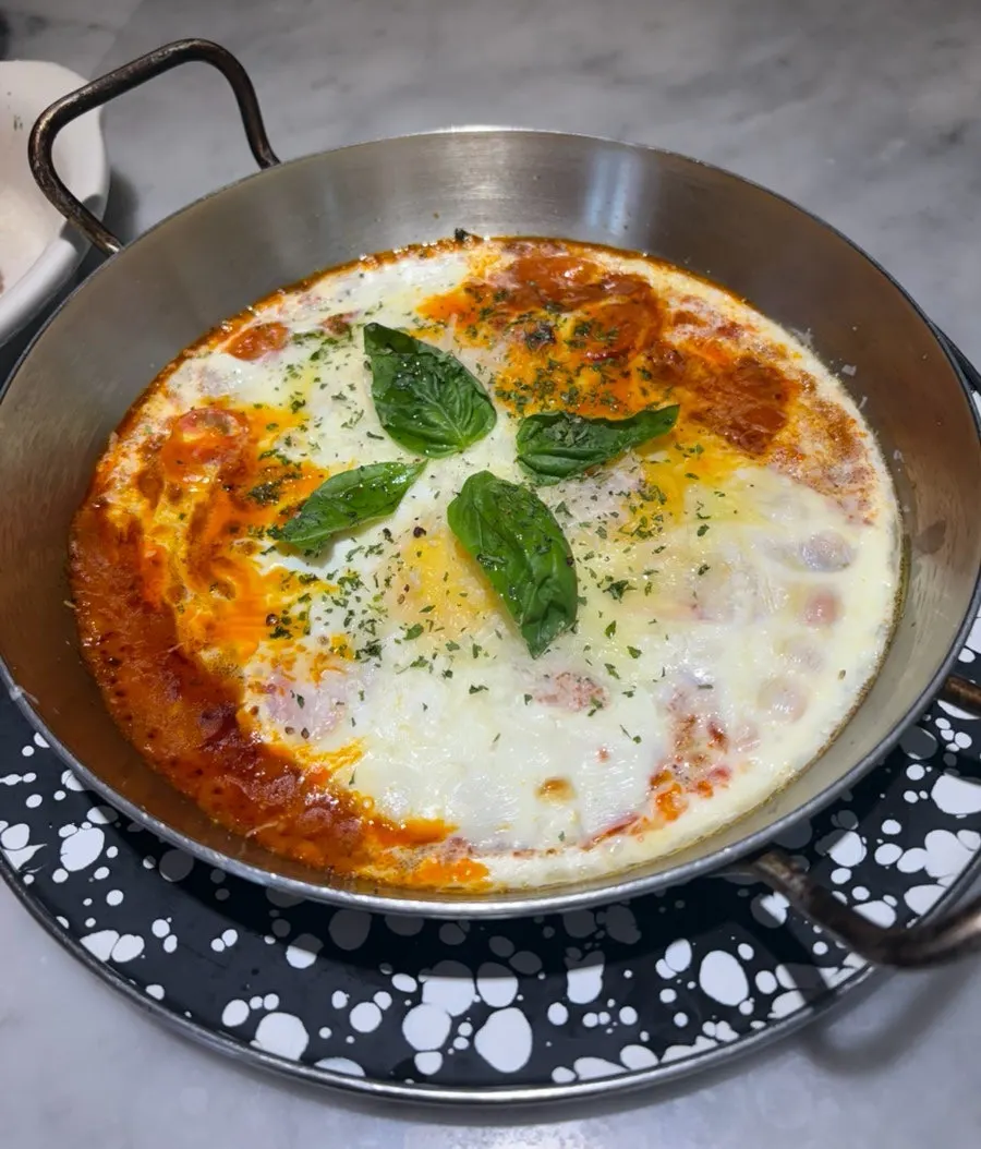 Egg in hell with soft-cooked eggs in tomato sauce