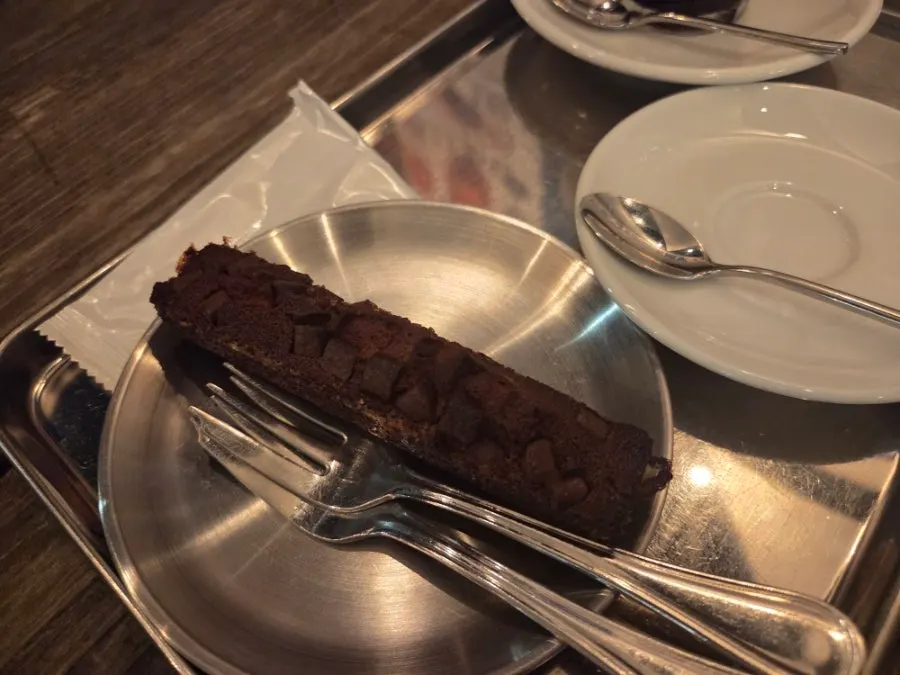 A slice of thick, dense chocolate financier
