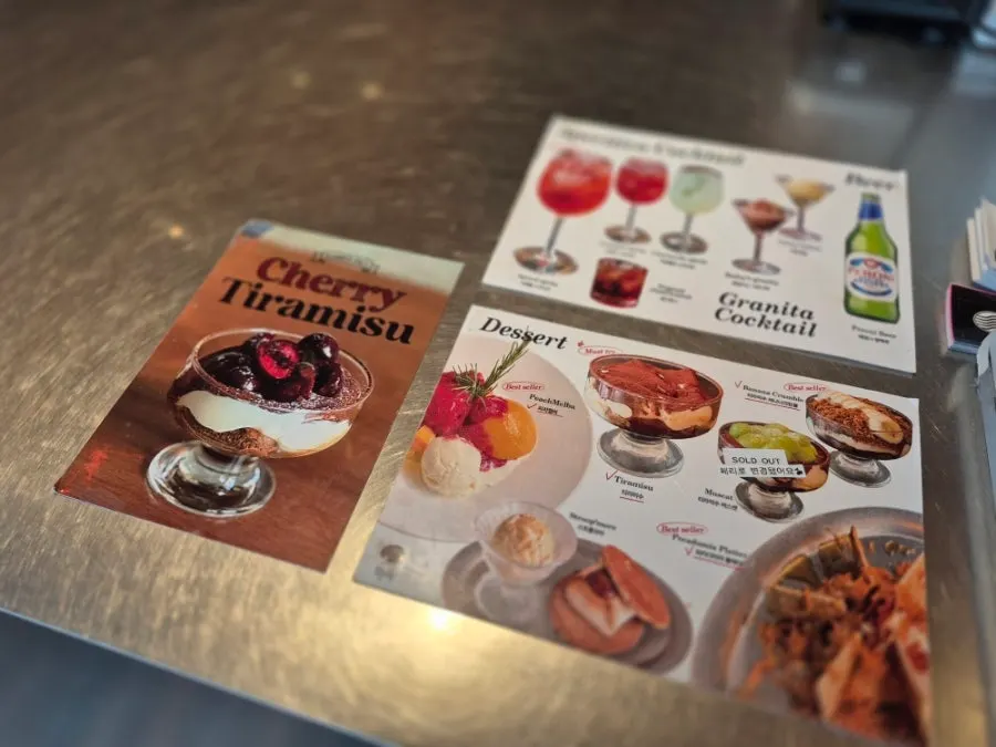 Cream coffee menu items listed on the menu board