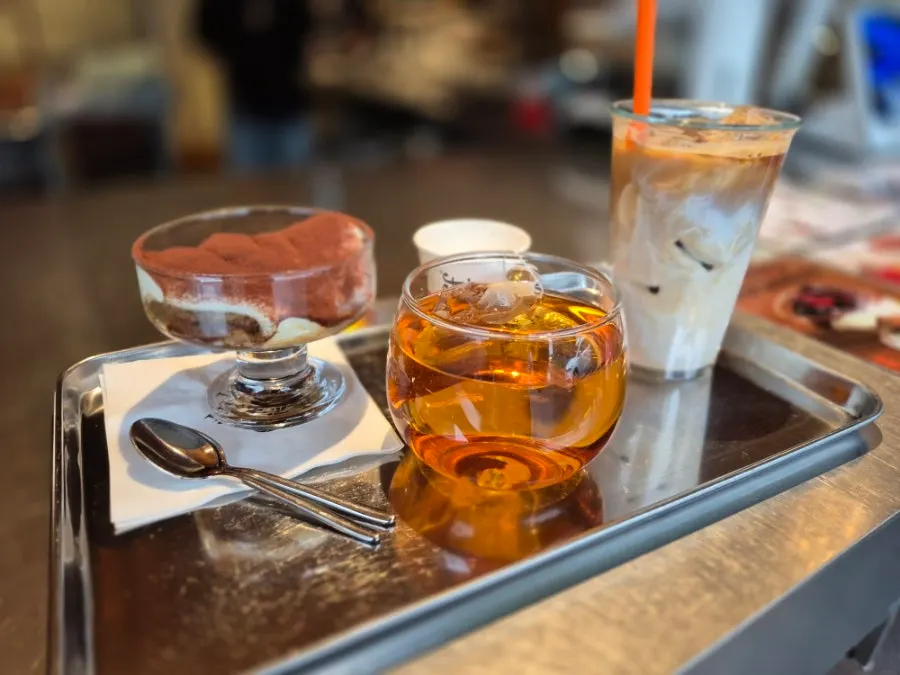 Iced latte and dessert set on the table