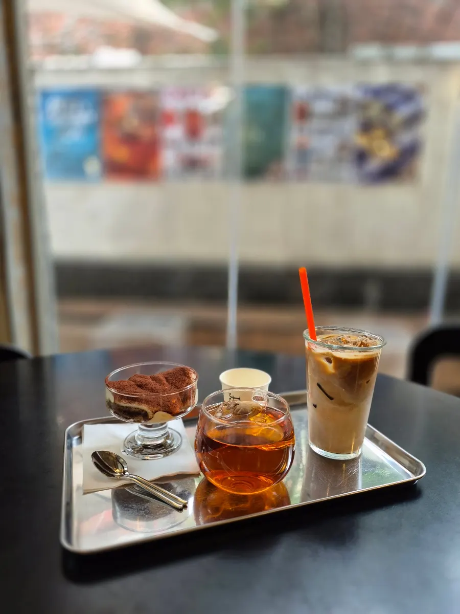 Coffee, tea, and tiramisu arranged together on the table