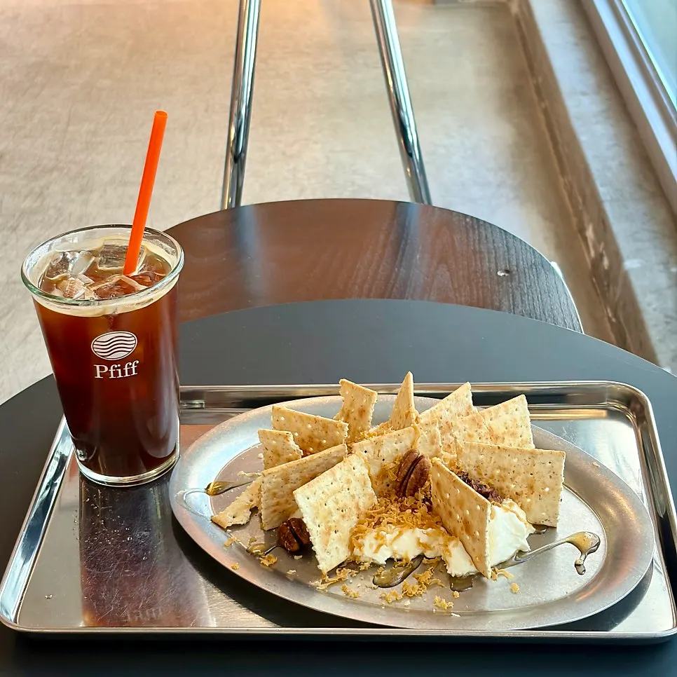 Dessert and coffee placed by the window seat
