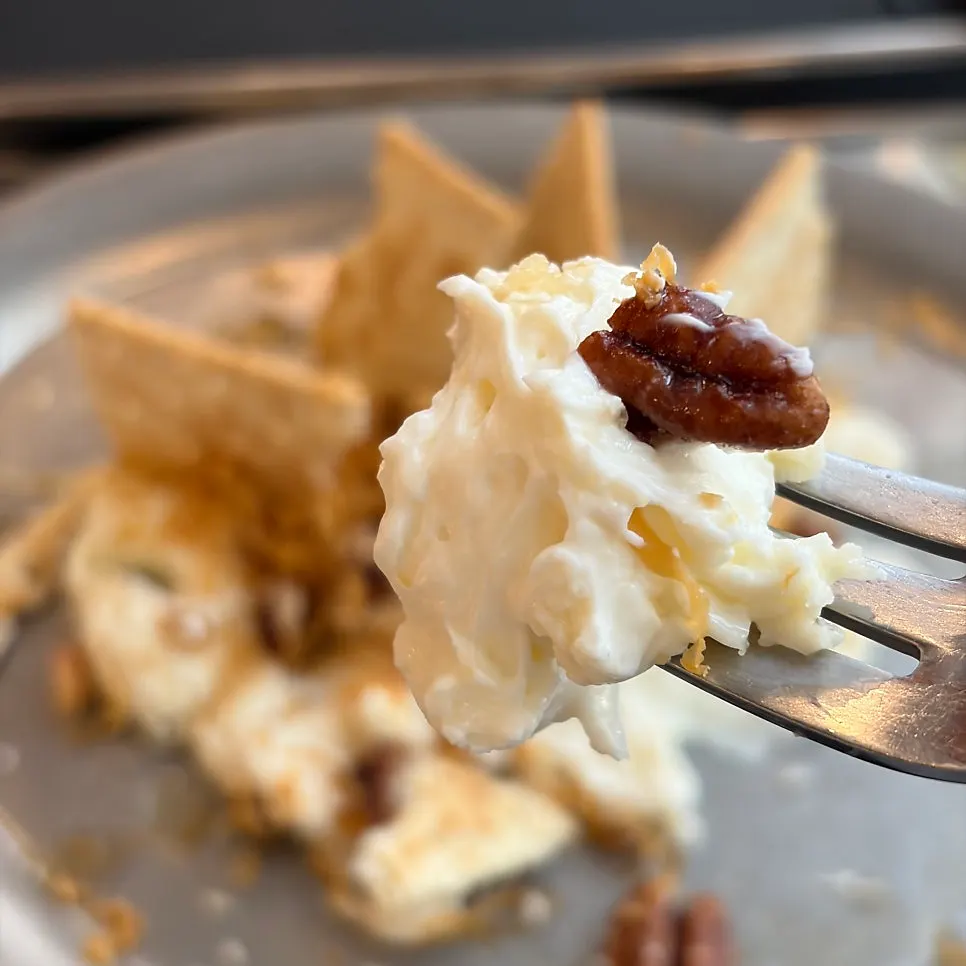 Cracker topped with brown cheese