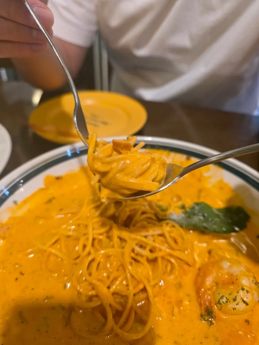 Rosé pasta noodles twirled on a fork