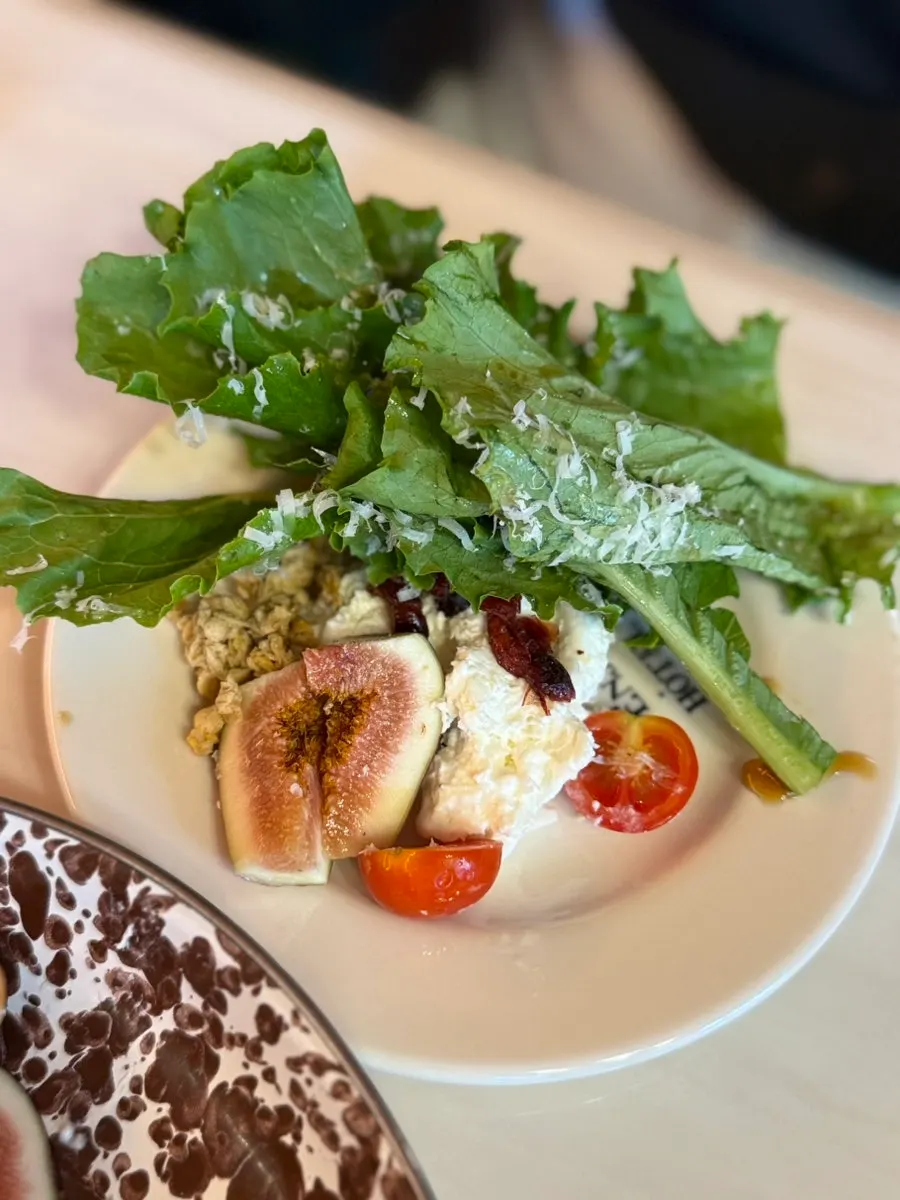 Seasonal fruit salad topped with a whole burrata cheese