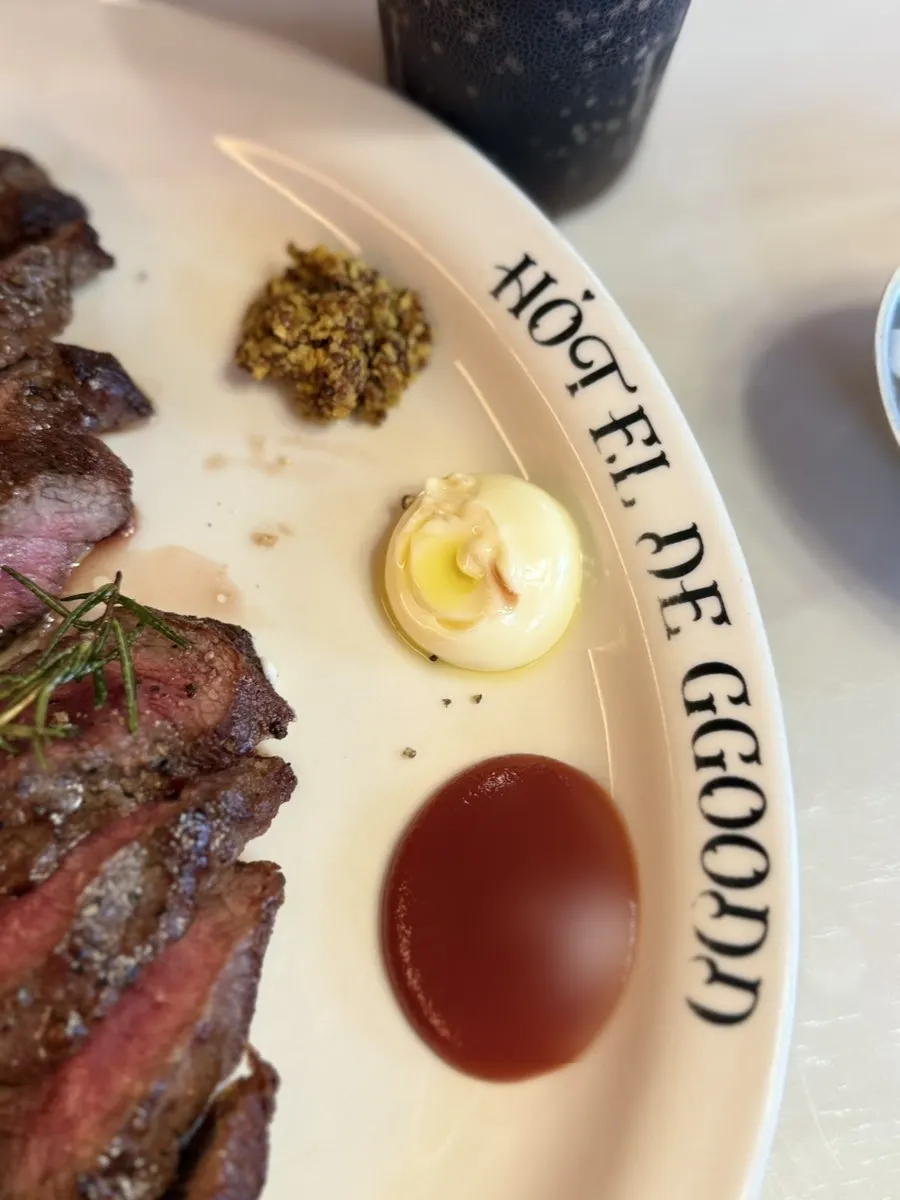 A slice of house steak showing juicy interior