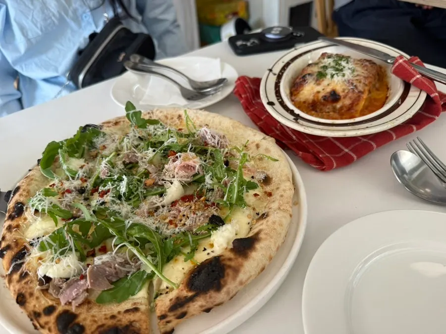 Classic lasagna served covered with a cloth