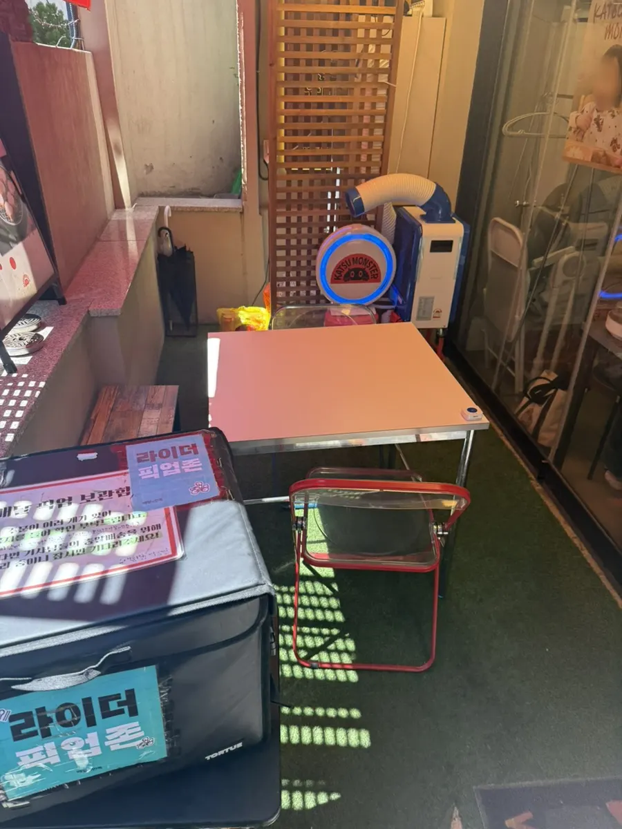 Two-person terrace seating in front of Katsu Monster Yeonnam Main Branch