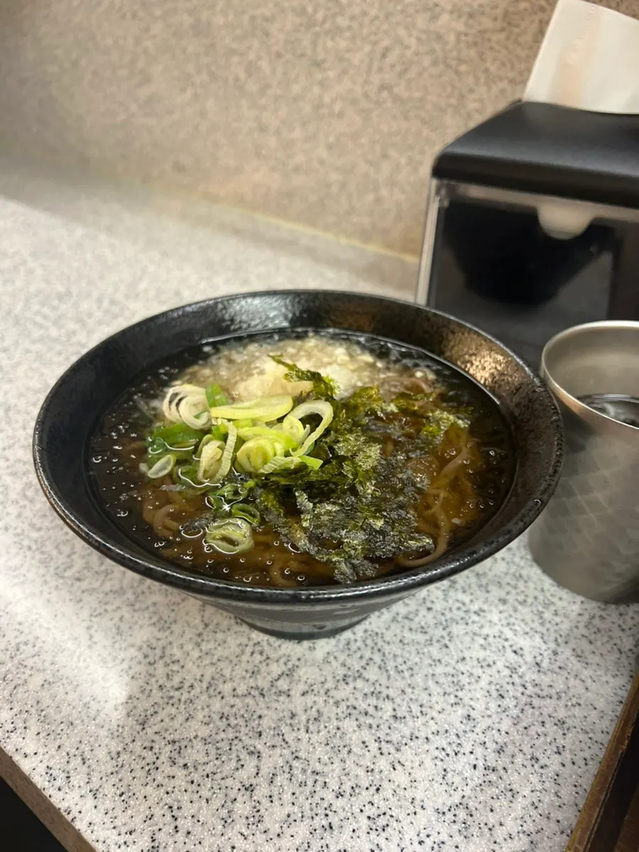 Soba noodles lifted up with chopsticks