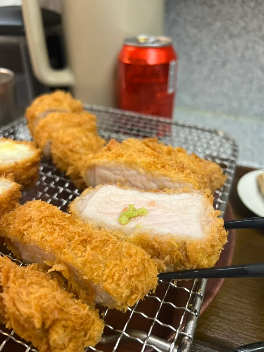 A bite of tonkatsu topped with wasabi