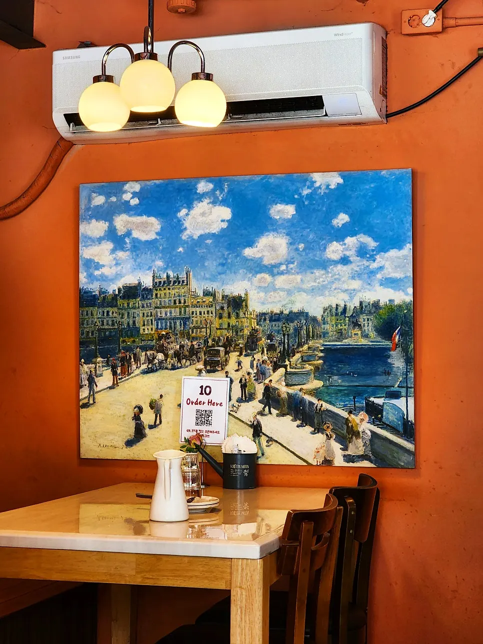 Restaurant interior with framed paintings and lighting