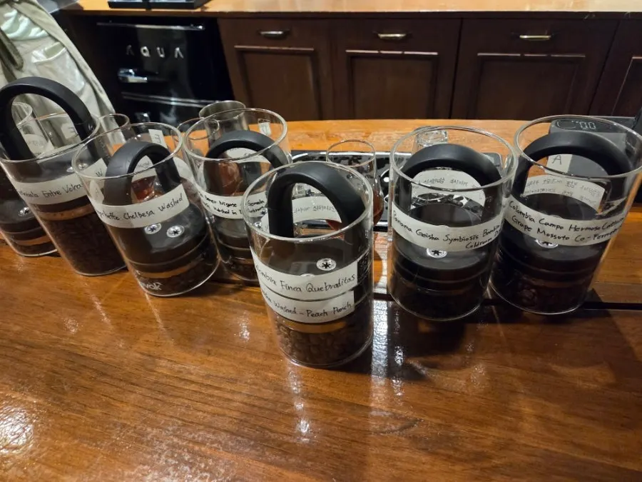 Specialty coffee beans displayed in vacuum glass jars