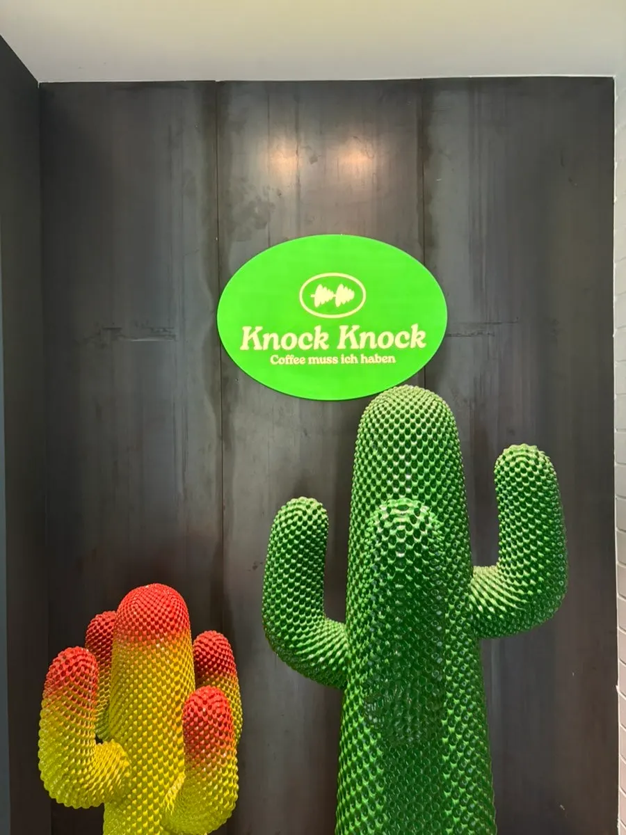 A cactus tucked between the stairs leading to the 2nd floor