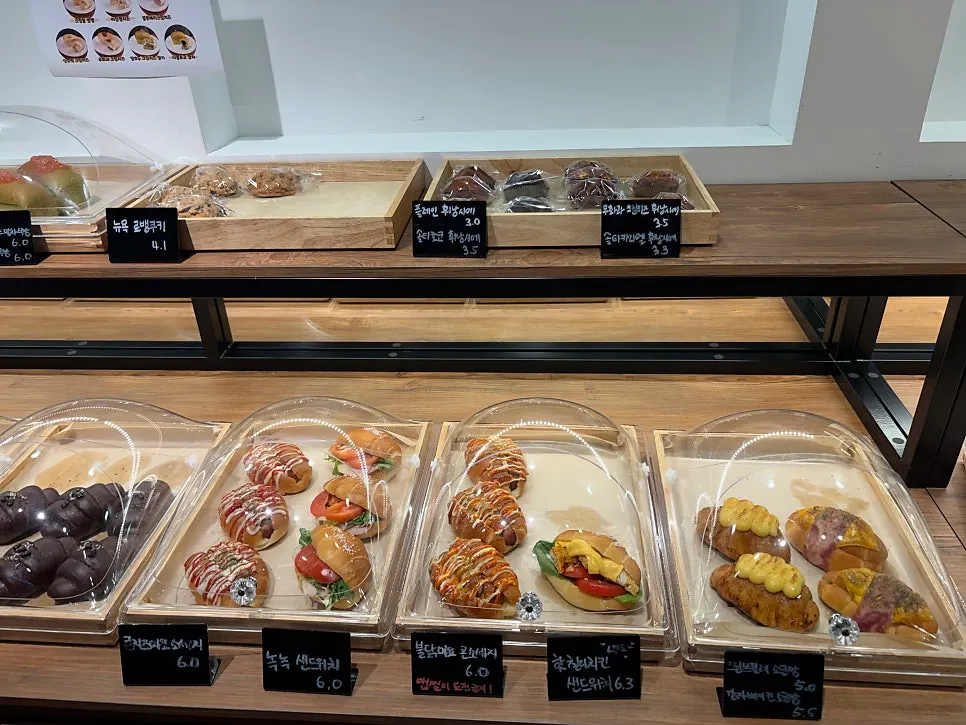 Salt bread and croissants on the bakery display shelf