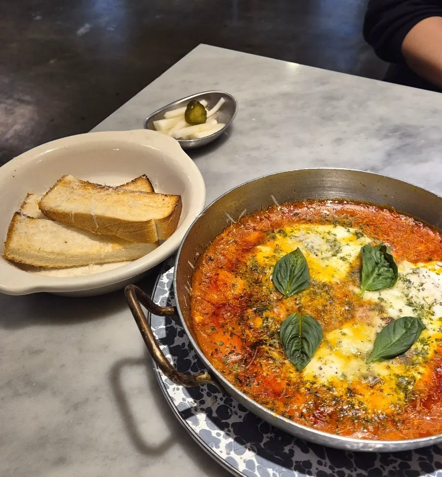 Egg in hell loaded with tomato sauce and cheese