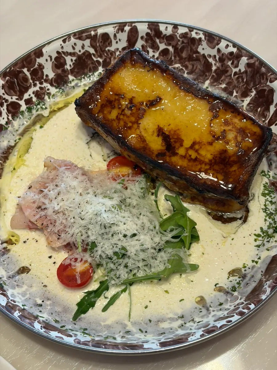 A plate of honey jambon cream French toast
