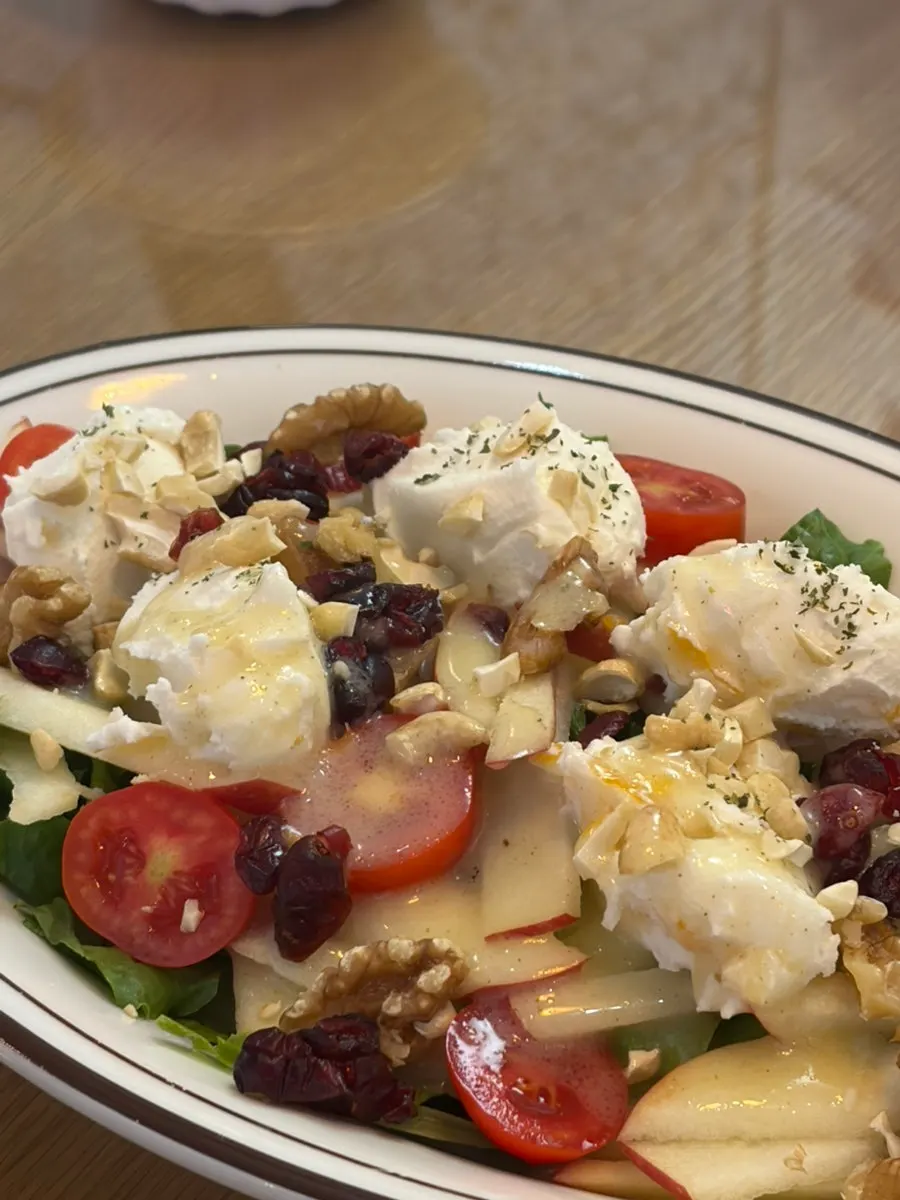 Ricotta cheese salad topped with fresh vegetables