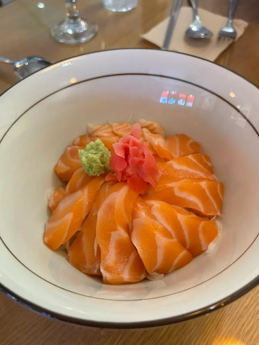 A bite taken from the salmon rice bowl