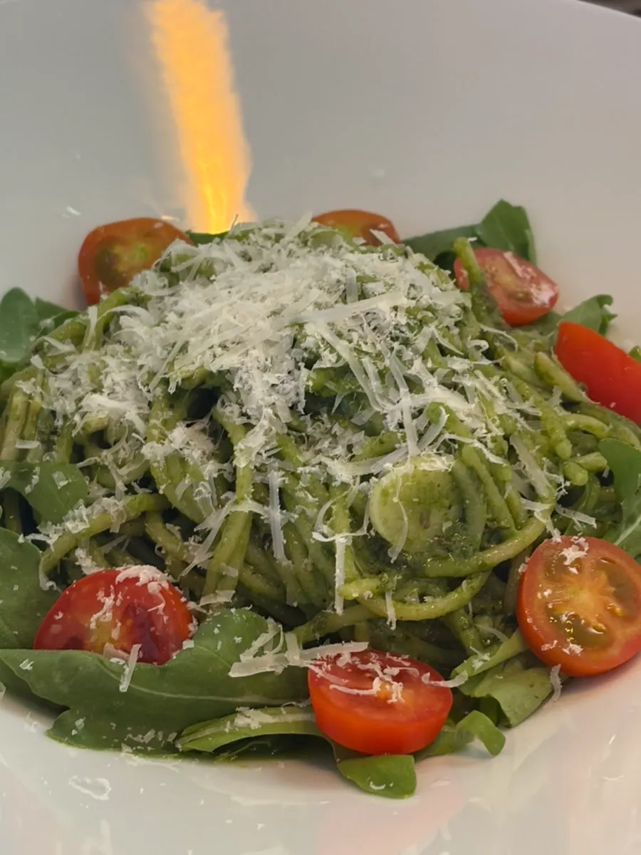 Basil pesto pasta twirled on a fork