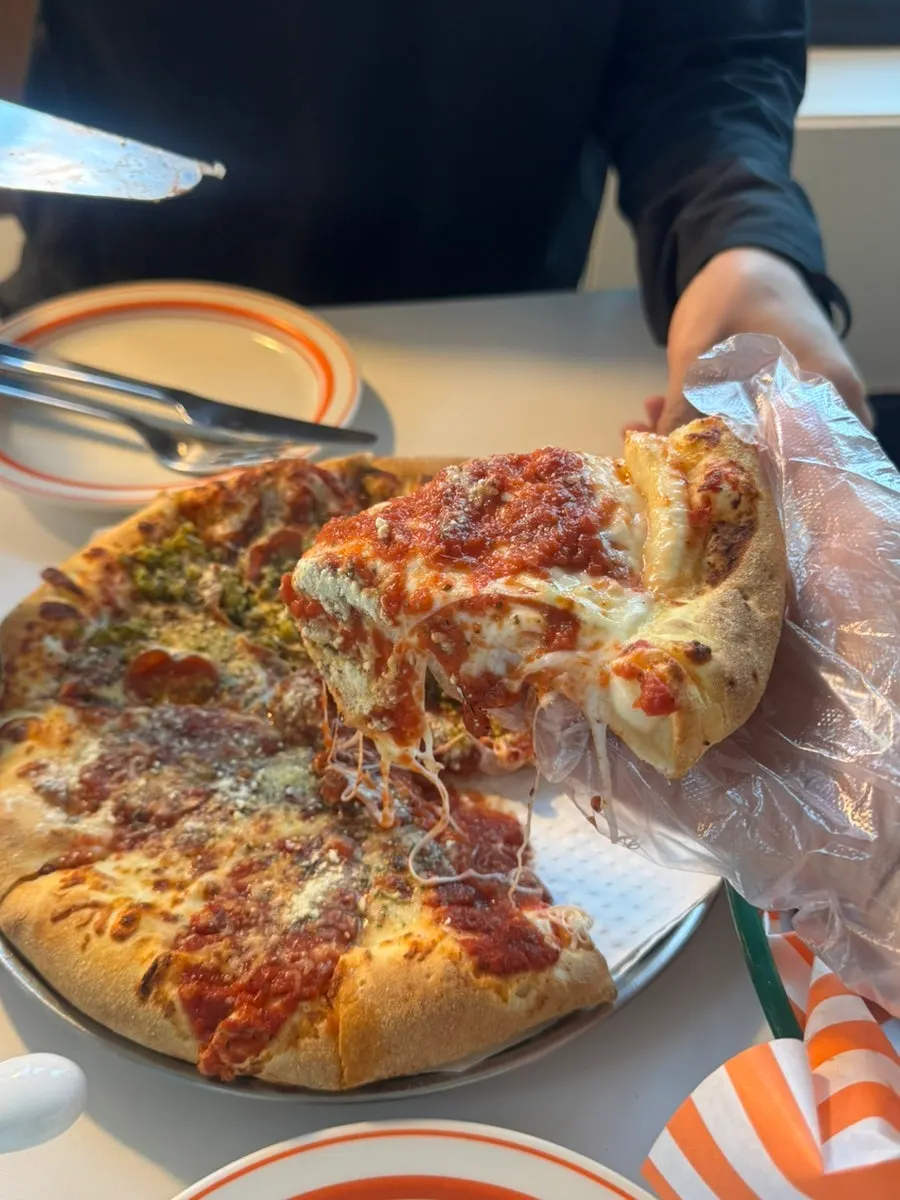 Cheese-filled slice of half-and-half pizza