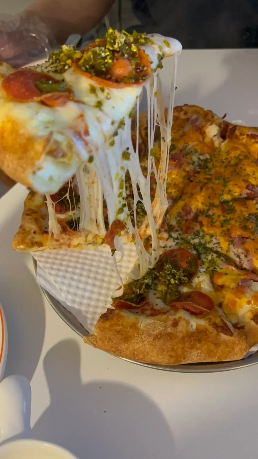 A pizza slice with stretching cheese