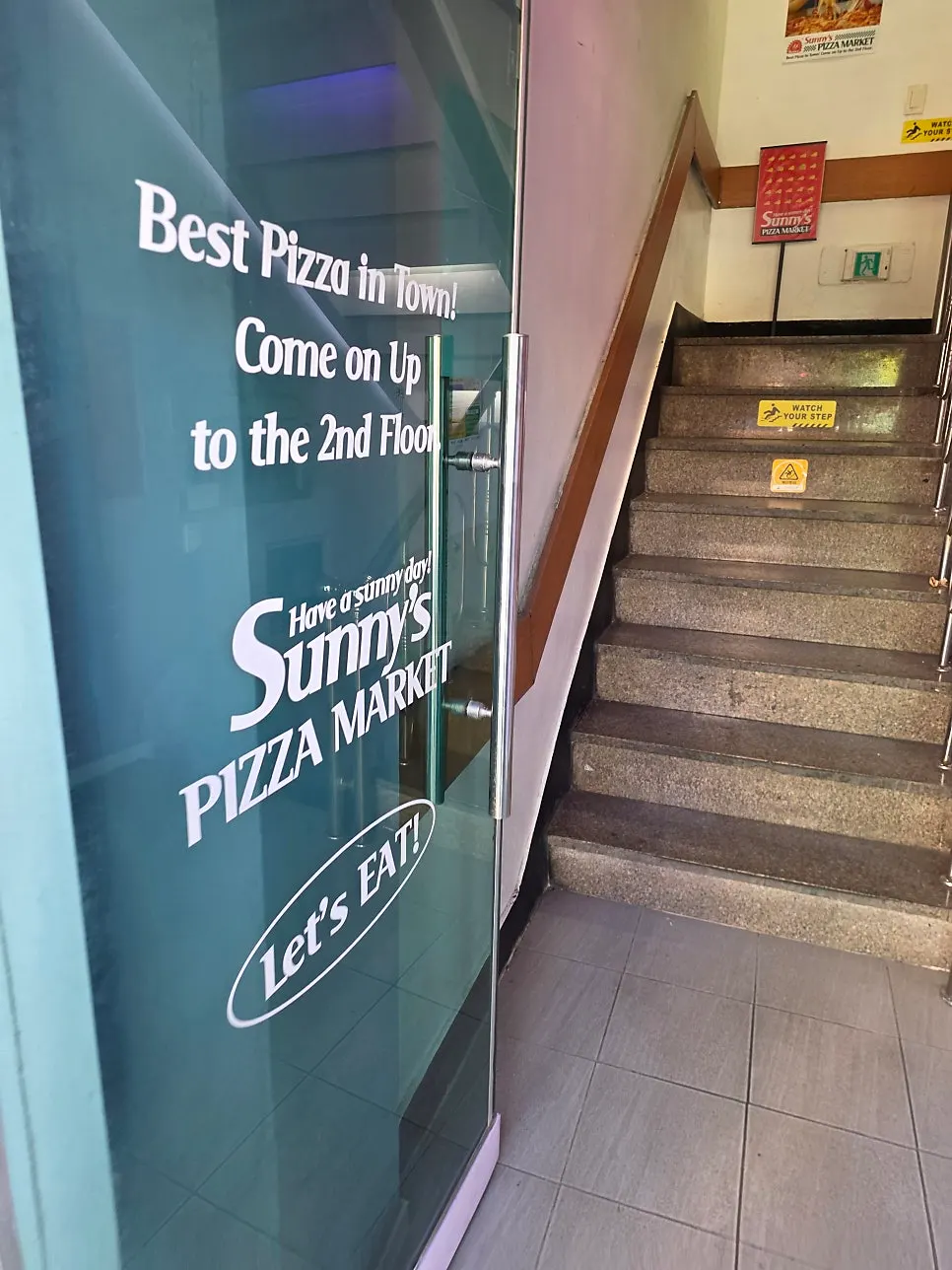 Stairs leading up to the second floor of Sunny's Pizza Market