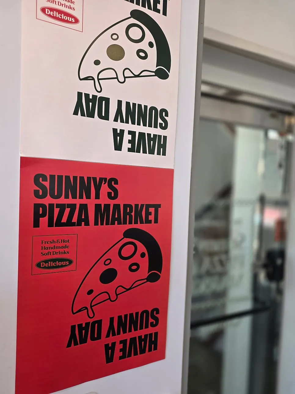 Interior of Sunny's Pizza Market with the folding doors open