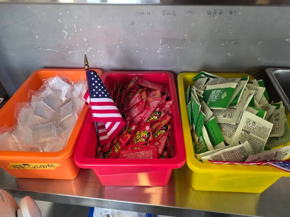 Self-serve corner with tissues and sauces at Sunny's Pizza Market