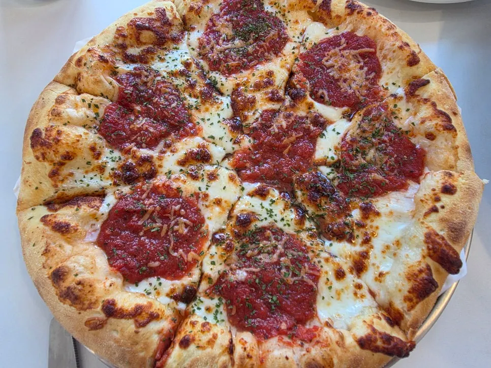 A whole margherita regular pizza at Sunny's Pizza Market