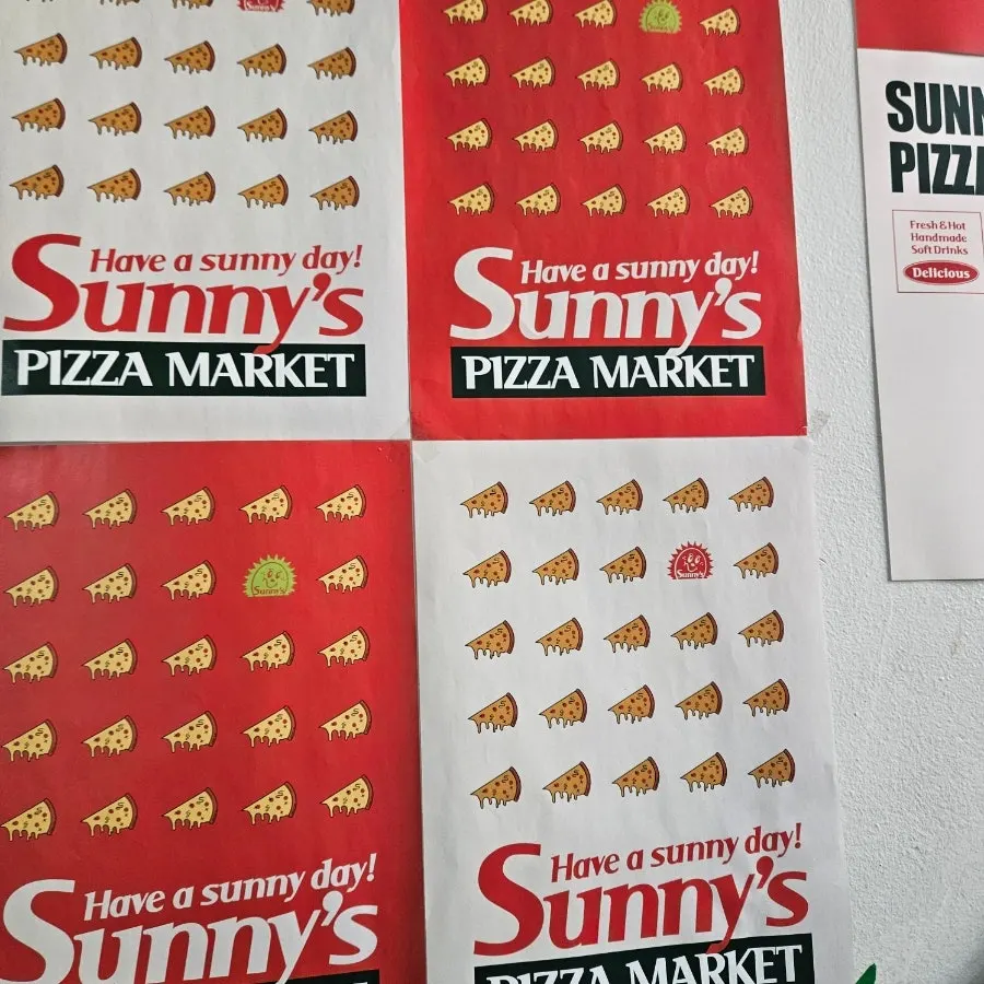 Business hours sign and 2nd-floor entrance of Sunny's Pizza Market
