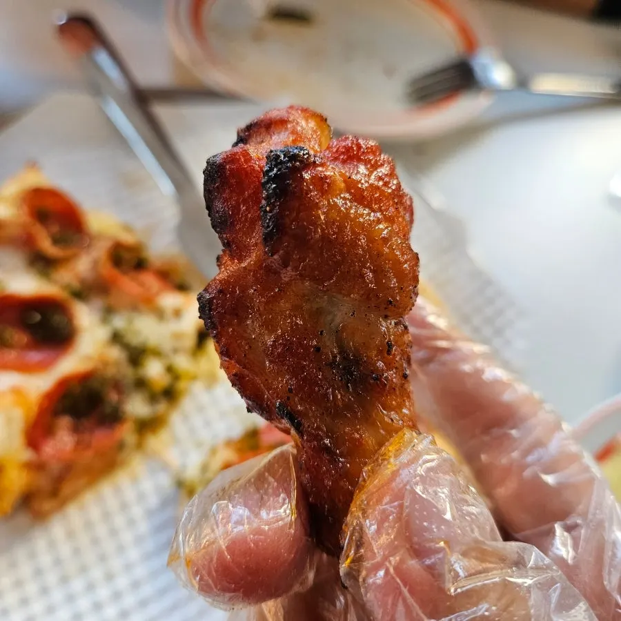 The last slice of pizza dipped in garlic dipping sauce