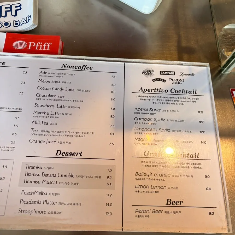Menu board listing drinks and cocktails