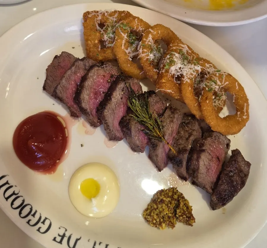 A piece of steak dipped in sauce