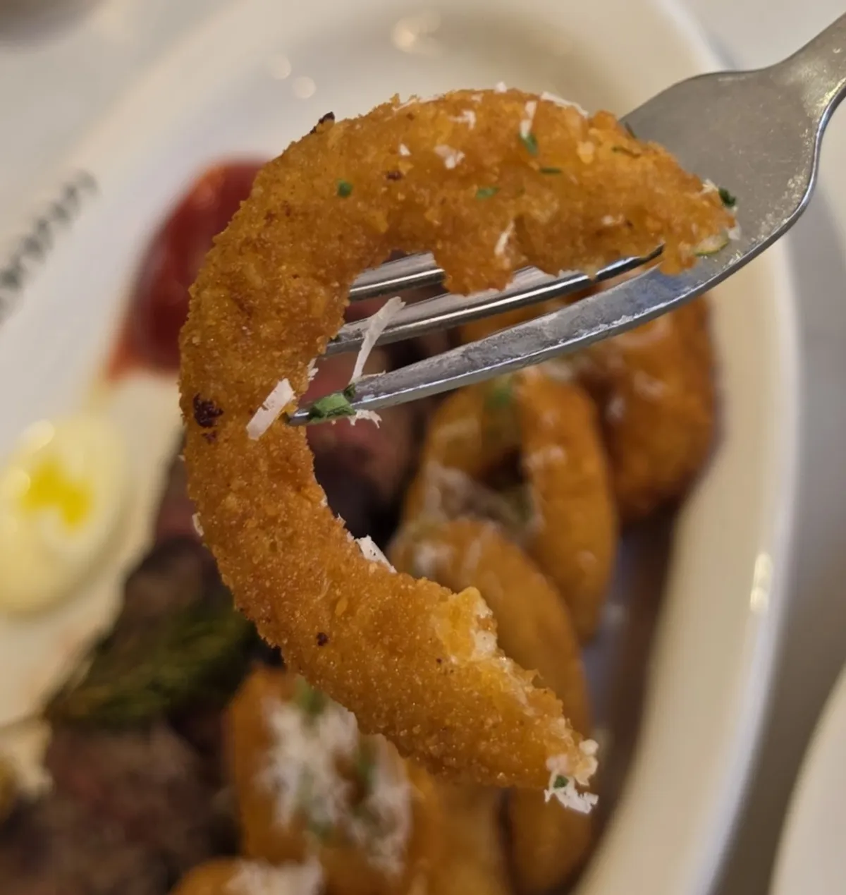 Steak plate served with hash browns and onion rings