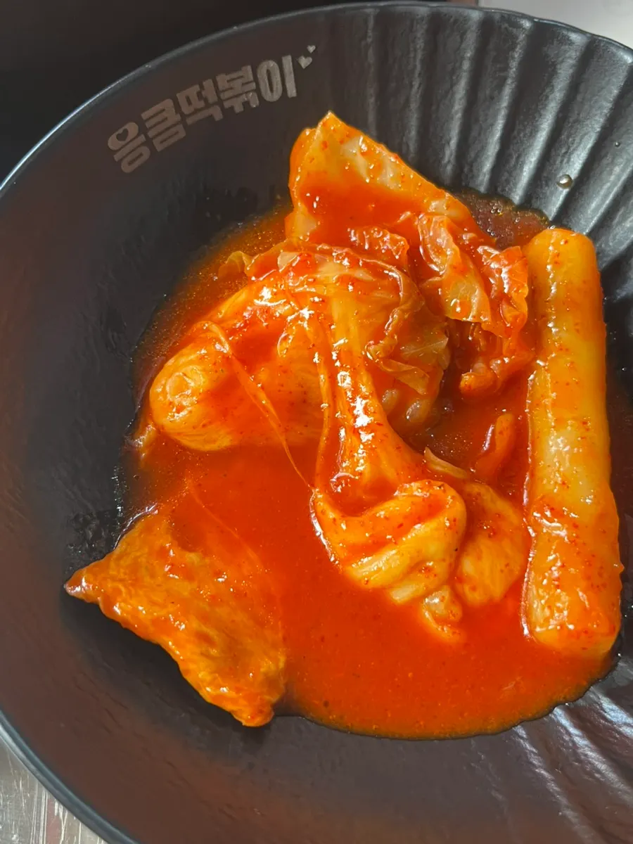 Stretchy cheese pulled up from the tteokbokki