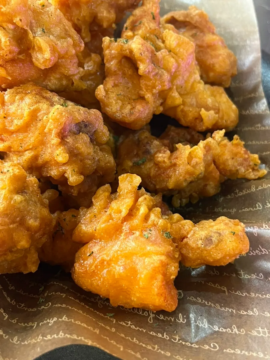 Freshly fried chicken pieces