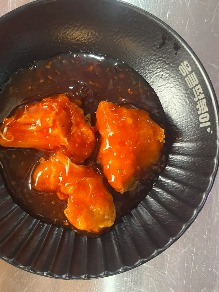 Tteokbokki and fried chicken served together at the table