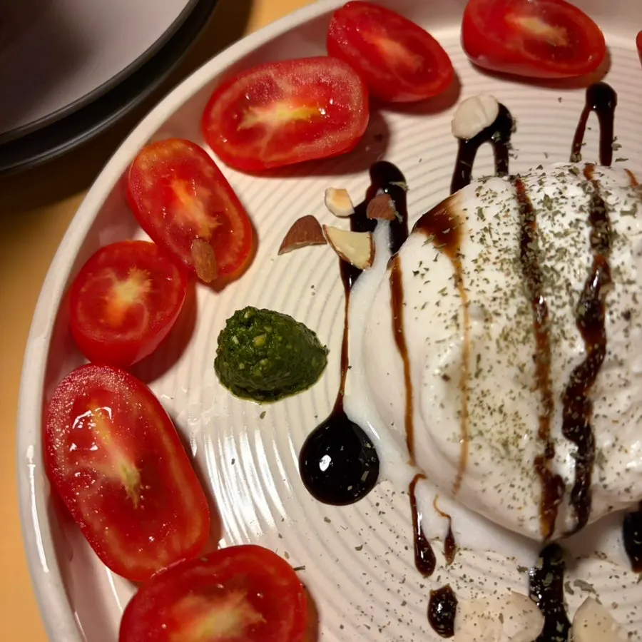 Caprese topped with basil pesto and balsamic glaze