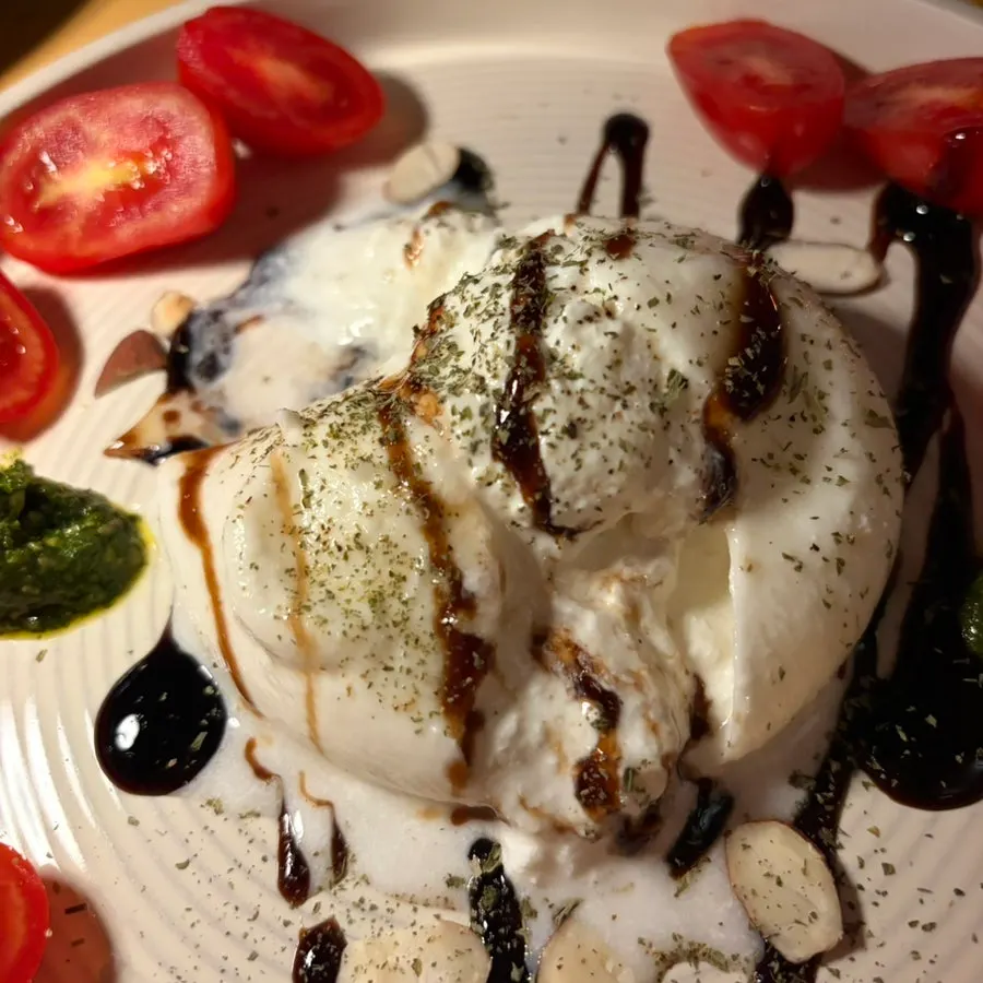 A forkful of burrata cheese and cherry tomato