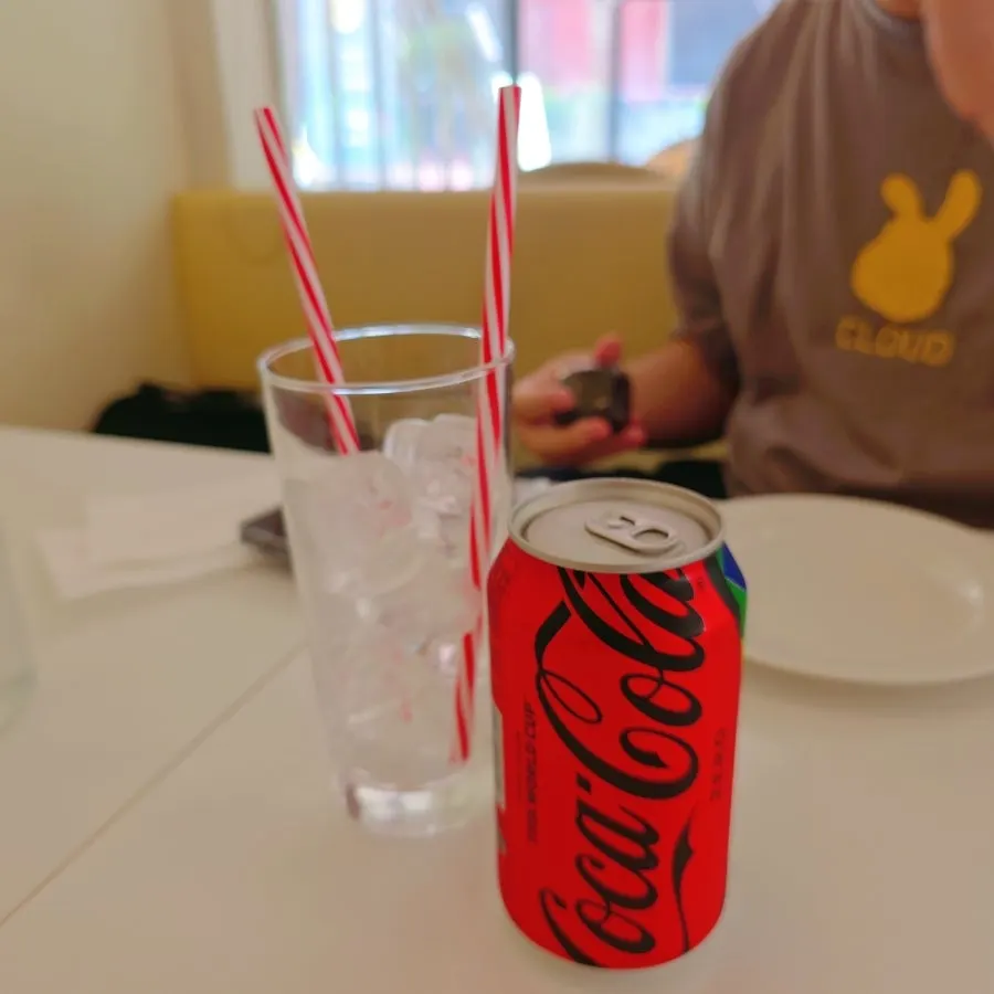 Meal with garlic bread and Zero Coke