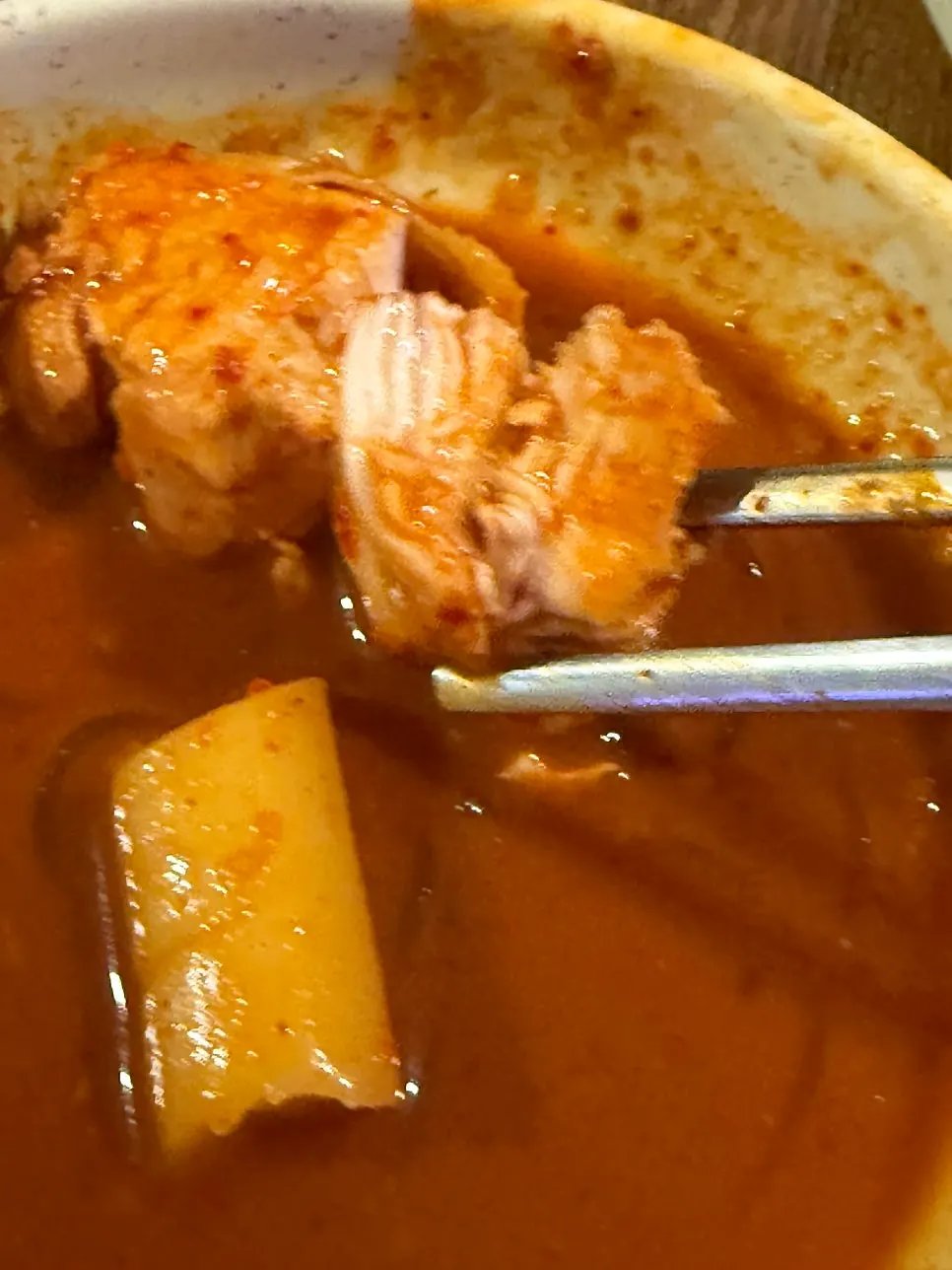 Fried chicken dipped into the chicken stew broth